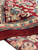 Pile thickness and hand-knotted reverse visible at the folded red corner of the rug