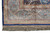 Corner detail of ivory and pale blue borders framing deep navy lattice cartouches and silk fringe