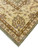 Ivory main border with scrolling vine and rosettes framing the pale green oversize wool rug