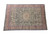 Navy and deep red oversize Persian rug photographed at an angle showing full floral border