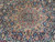 Central ivory and red star medallion surrounded by scrolling vines on deep navy ground