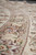 Angled macro of silk highlighted palmettes and vine scroll showing the low even pile