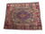 9'6" x 11'2" Kashmar rug photographed at an angle showing ivory border and crimson frame