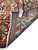 Back of the rug folded over, showing hand-knotted weave, cotton foundation and original dealer tag