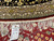 Hand woven Oriental rug tag marked 6772 and size 10 x 10 beside ivory fringe