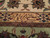 Close-up of woven signature cartouche in apricot guard border of this hand-knotted Tabriz rug