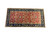 Angled studio shot of the oversize wool rug, red field framed by deep navy border