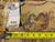 Back tag reading rug number 26609 and size 11.8 x 15.8 beside measuring tape