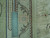 8x10 Chinese silk rug photographed with a ruler to show knot density along the edge