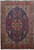 Full view of 8'2" x 12'1" Persian Tabriz rug with dark indigo field and red star medallion