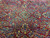 Deep red field scattered with blue and gold flowering sprays across this antique Persian weave