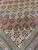 Corner spandrel detail with layered sage, blue and mauve scallops above narrow guard borders