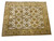 Angled floor shot showing saffron gold main border framing the cream field of this wool rug