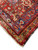 Bright red and blue corner border detail with selvedge, fringe and rosette filled guard stripes