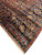 Navy border corner resolution with coral guard stripe, olive leaves and hand-tied wool fringe end