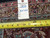 Rug back with tape measure and tag reading genuine hand woven Oriental rug 6379, 8.6 x 11.8