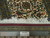 Ruler against fringe end proving authentic hand knotted Persian weave and fine knots per square inch
