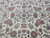 Macro of the central floral repeat with pale blue accents, rose blossoms and fine knotting