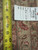 Back of rug with tape measure and tag reading rug number 6373, size 8.6 x 11.10