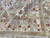 Folded corner exposing the tightly woven back and hand-knotted foundation of this oversize wool rug