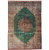 Overdyed green Persian Qum silk rug with copper medallion and ivory floral borders, studio view