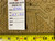 Back tag reading rug number 6486 and size 10.5 x 13.6 beside a measuring tape