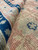 Macro view of the wool pile and weave revealing this antique rug's hand-knotted structure