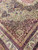 10 x 13'3" Kermanshah rug corner showing burgundy spandrel and layered flowering borders in rose