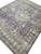 Corner perspective showing lavender gray field, sage green main border and golden palmettes across the rug