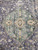 Close-up of the sage green center medallion with brown and ivory geometric core detail