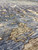 Angled macro of the wool pile showing an animal figure and small birds in flight