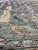 Close view of an ivory bird motif resting on the sea green inner border