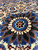 Extreme close-up of one blue and ivory rosette revealing short even wool pile height