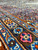 Border detail with pink and blue palmettes on olive brown ground, hand knotted wool