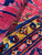 Folded corner revealing dense hand-knotted weave, saffron gold border and thick lustrous wool pile