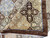 Folded corner revealing even knotting, brown selvedge and the soft natural wool pile texture