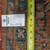 8'2" x 11'8" Sarouk back with dealer tag and tape measure confirming the rug dimensions