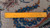 Reverse of the rug with a ruler across the weave showing the knots per square inch
