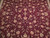 Close-up of all-over vine scroll with peach palmettes and sage leaves on burgundy ground
