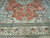 Deer, birds and flowering trees woven across the coral field above the ivory main border