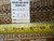 Back tag reading rug number 6160 with tape measure across the tightly knotted wool weave