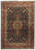 Full overhead view of navy blue Persian Tabriz rug with red border and green star medallion