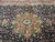 13x20 Persian Tabriz rug close-up of green and burgundy star medallion on navy field
