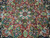 Macro of medallion core showing ivory rosettes, olive green arabesques and silk highlighted burgundy scrollwork
