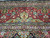 Burgundy main border detail with pistachio palmettes, ivory guard stripes and fine multicolor floral vinework