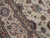 Close-up of blue, green and rose palmettes with fine brown vine scroll on ivory ground