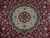 Close-up of ivory and navy star medallion with rose palmettes on deep red Tabriz field
