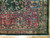 Corner detail showing raspberry rose border, gold guard stripes and ivory cotton fringe on wool pile