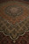 Perspective view showing dense knotting, cream tipped scallops and tan lattice across the wool pile