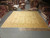 Oversize square Ziegler design rug laid flat on the warehouse floor for full scale reference